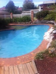 Completed concrete swimming pool repairs in Blue Mist finish